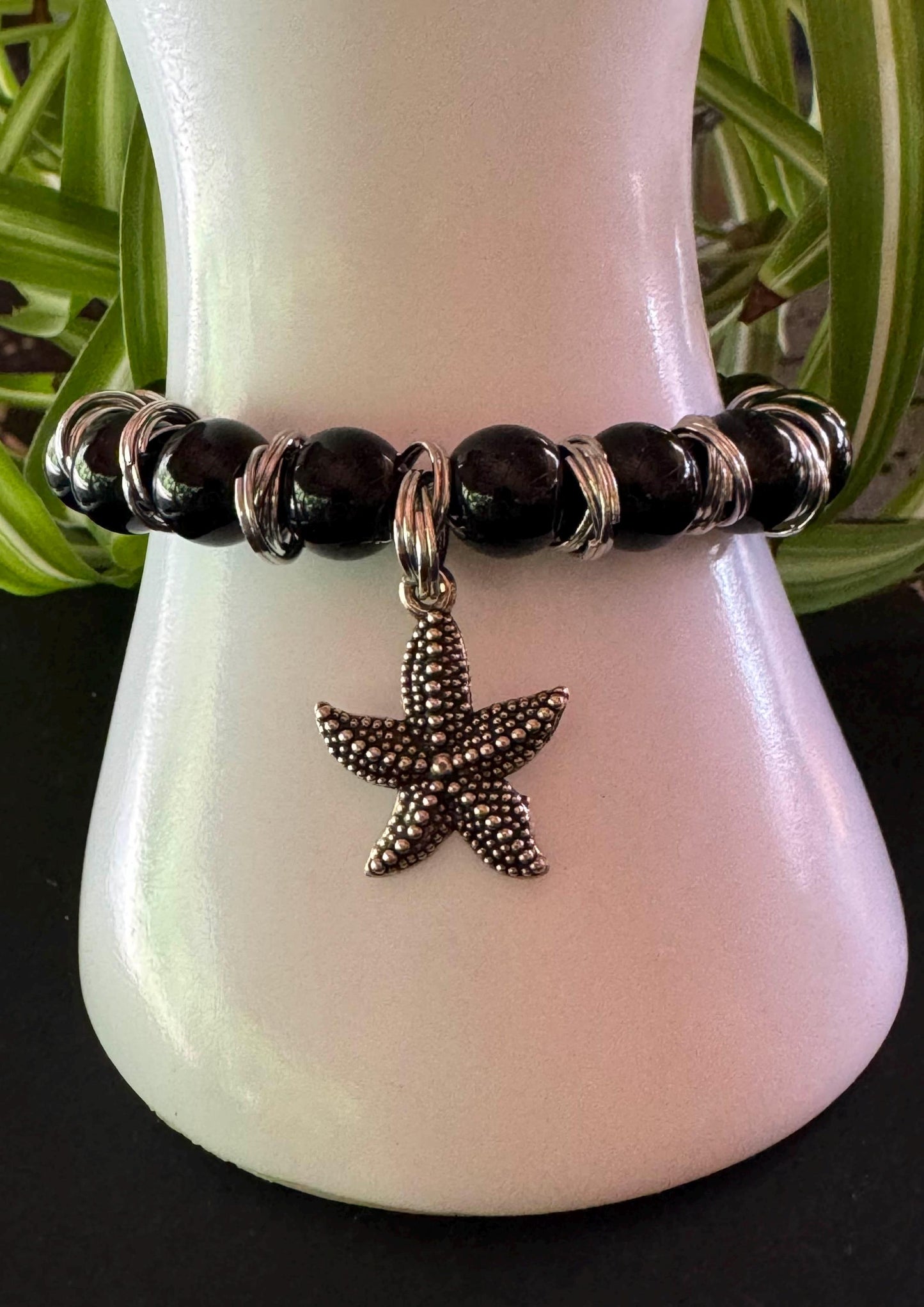 Handmade 10mm Black Onyx with Sea Star Charm Gemstone Bracelet - Strength & Serenity. Black Onyx Gemstone bracelet with silver spacers and hanging Seastar charm.