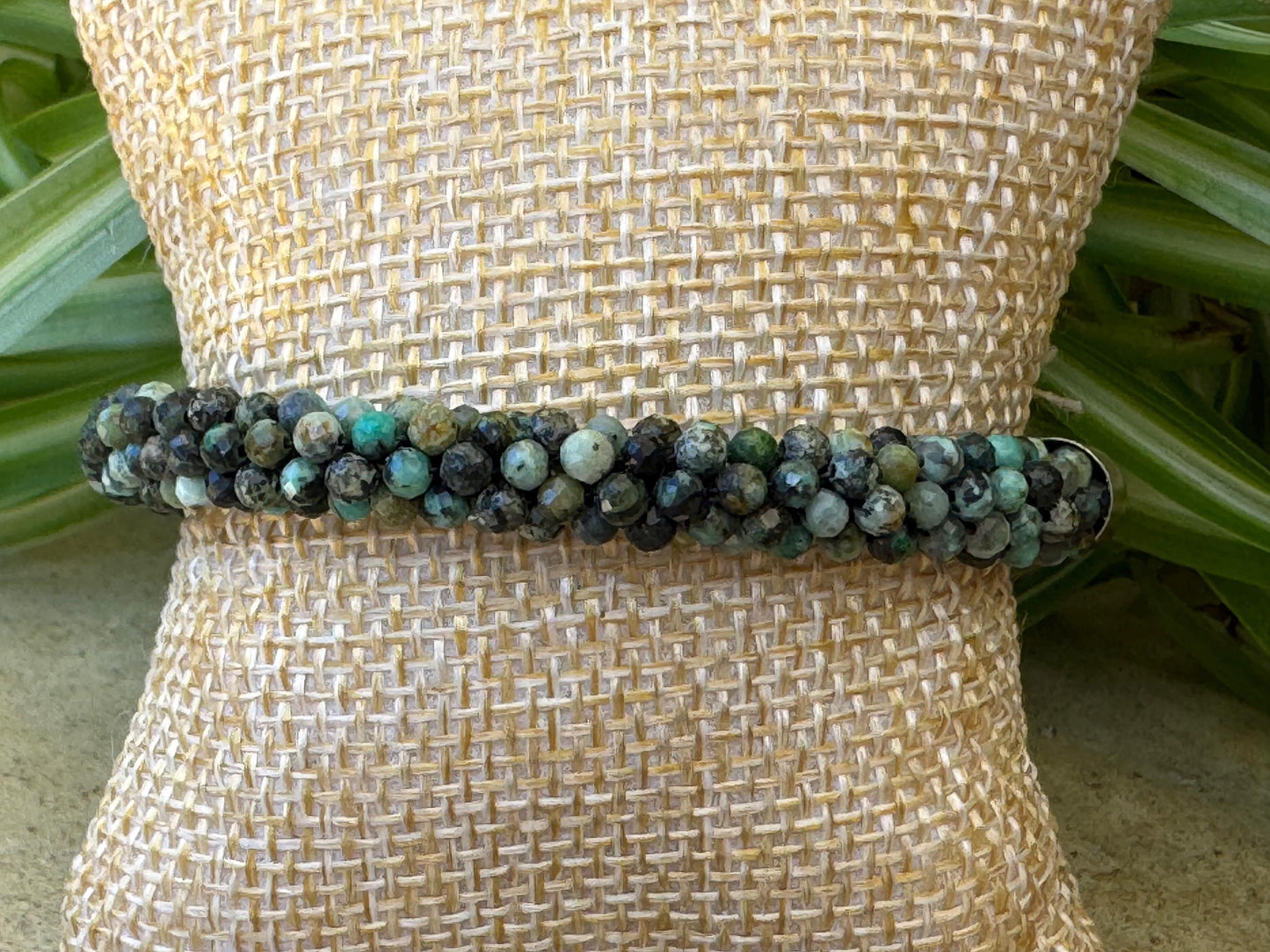 Kumihimo African Turquoise Gemstone Bracelet - African Turquoise Gemstone bracelet with golden flower hanging charm.