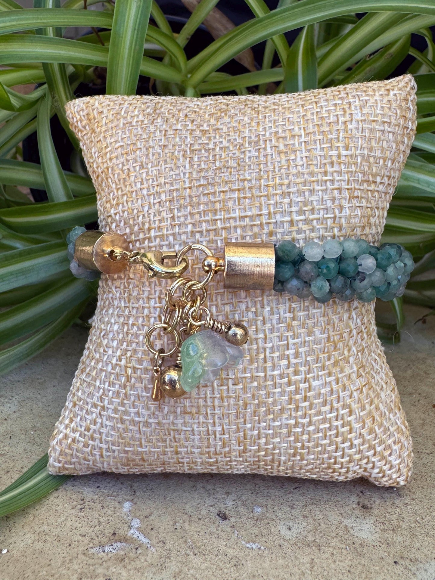 Kumihimo Emerald Gemstone Bracelet - Emerald Gemstone bracelet with golden flower hanging charm.