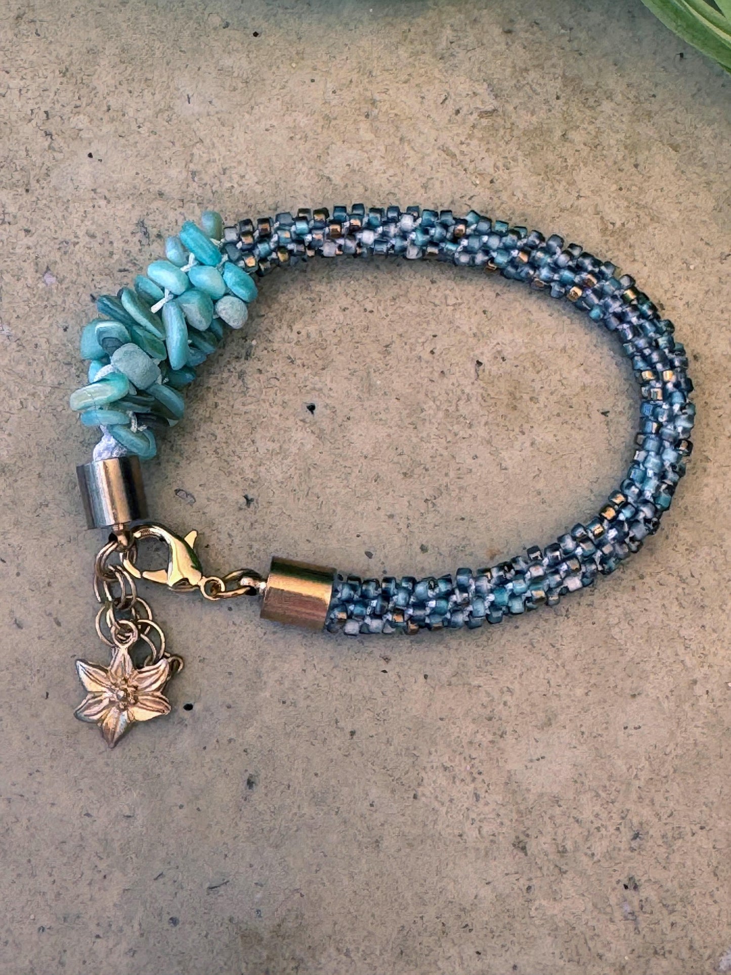 Kumihimo Blue Dyed Shell with Glass Bead Bracelet - Blue Dyed Shell with Glass Bead Bracelet with golden flower hanging charm.