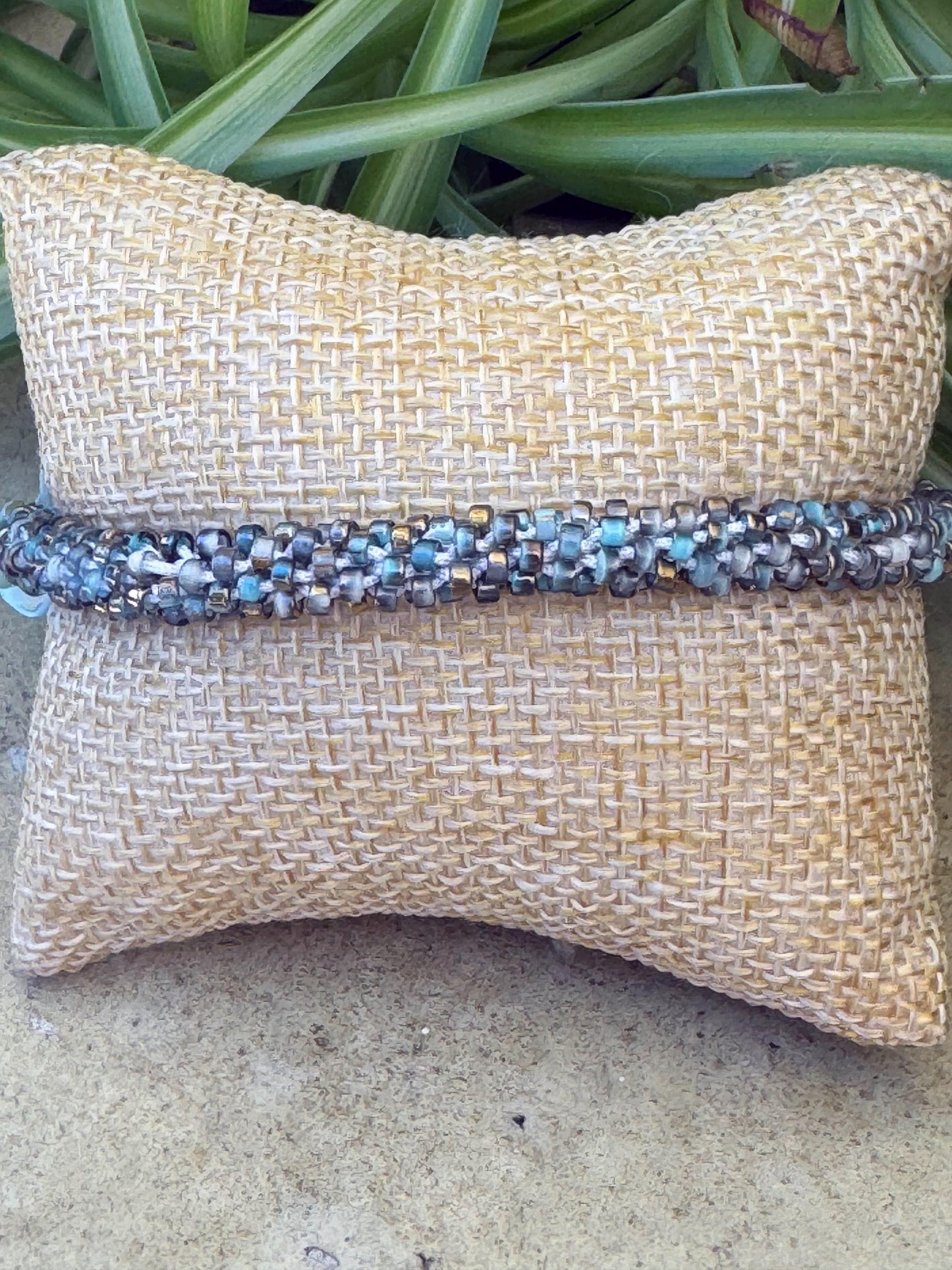Kumihimo Blue Dyed Shell with Glass Bead Bracelet - Blue Dyed Shell with Glass Bead Bracelet with golden flower hanging charm.