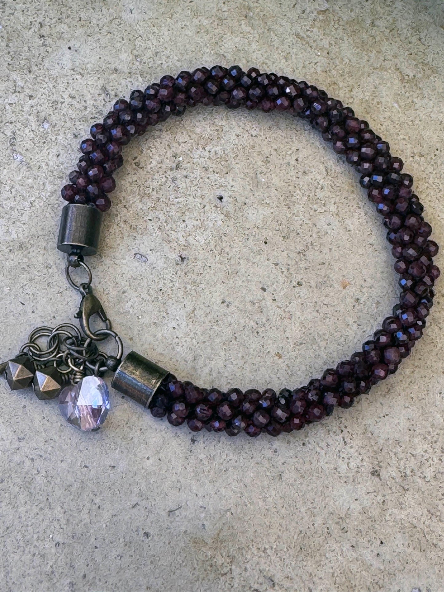 Kumihimo Garnet Gemstone Bracelet - Garnet Gemstone bracelet with flower hanging charm.
